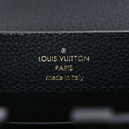 Louis Vuitton PARIS made in Italy stamp on black leather handbag.