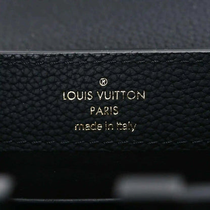 Louis Vuitton PARIS made in Italy stamp on black leather handbag.