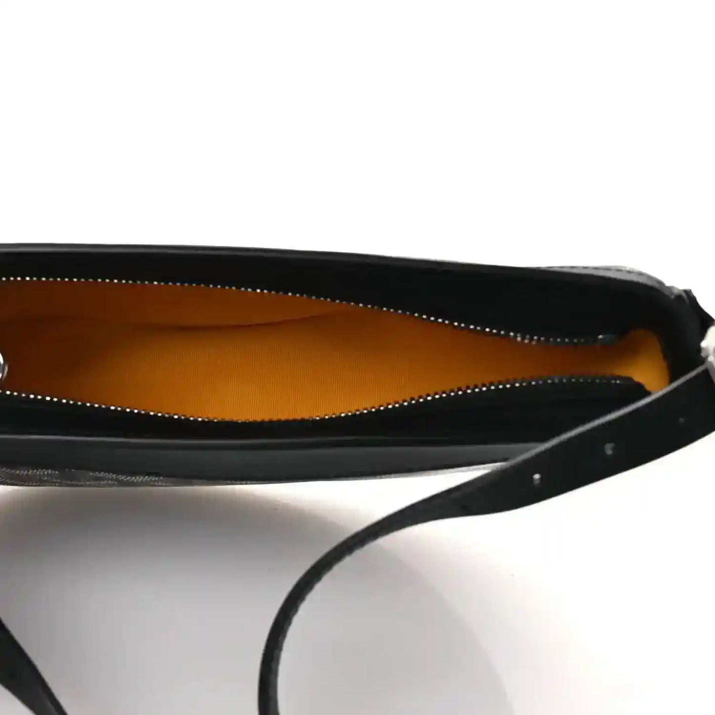 Open handbag interior with mustard lining and black zipper edge