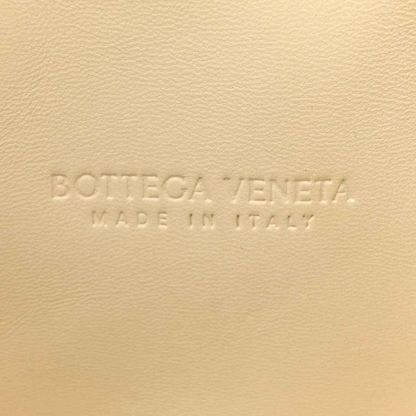 White leather clutch with Bottega Veneta embossed text and Made in Italy