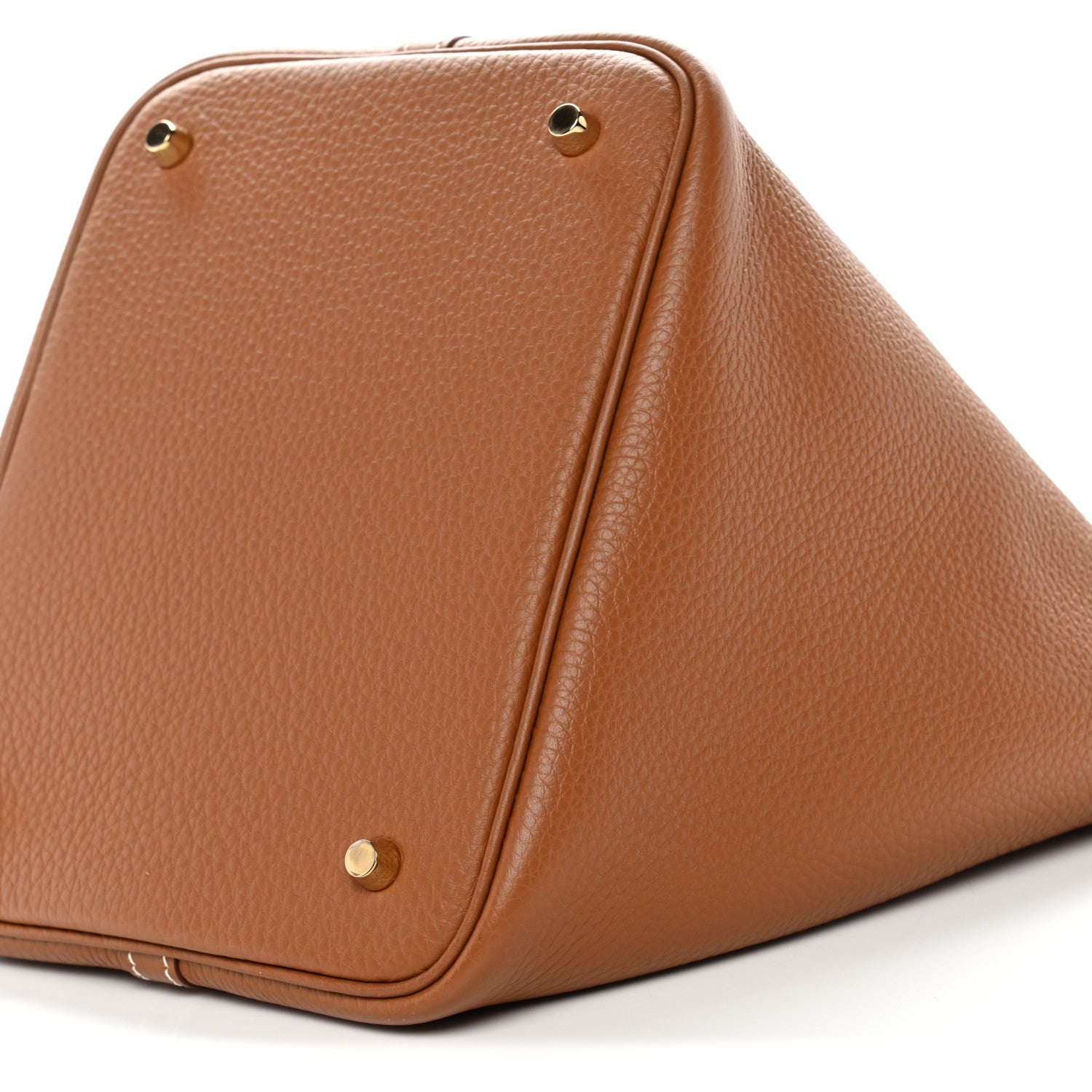 Tan leather bucket bag angled view with gold-tone snaps and curved top edges