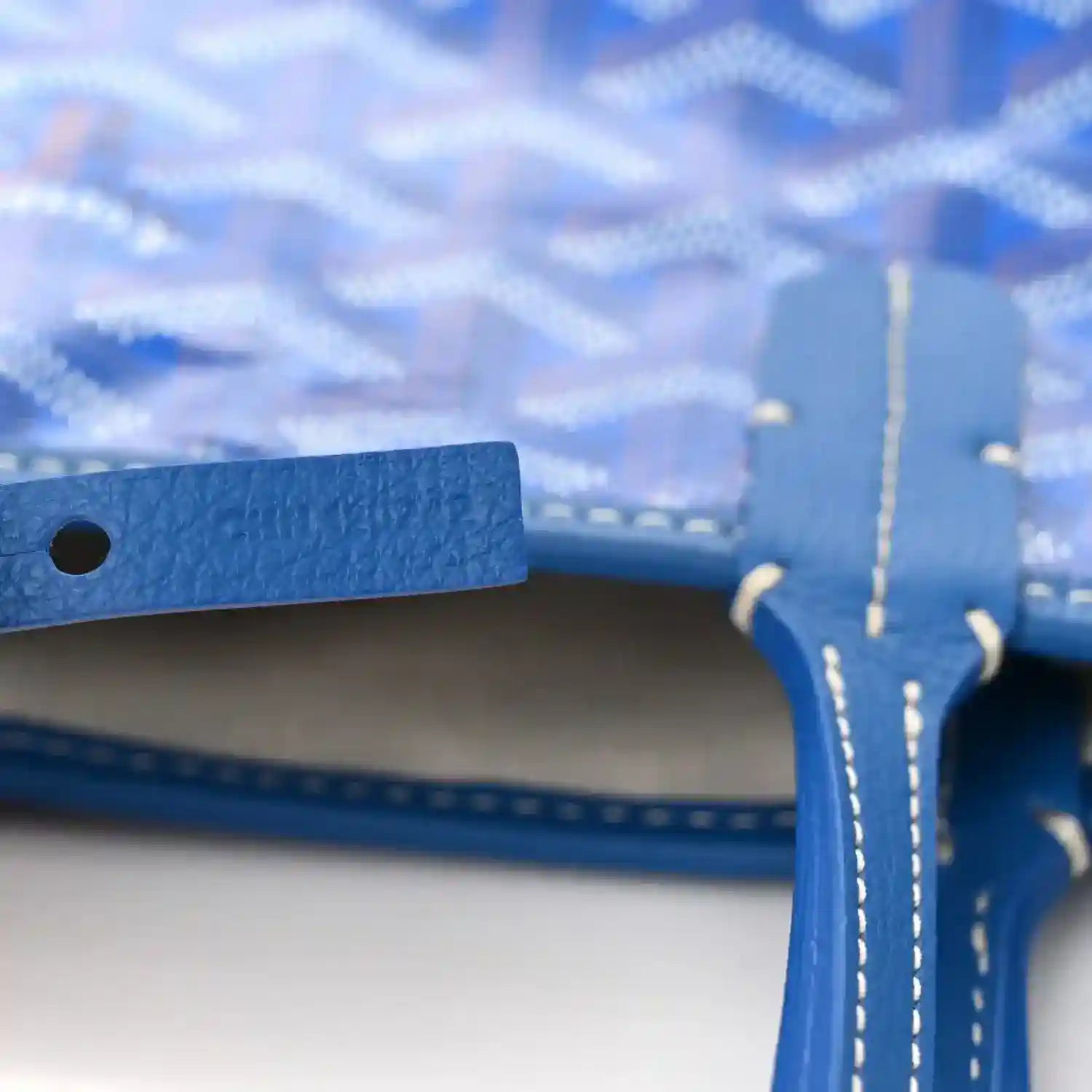 Open-top sky blue tote bag with blue strap and stitched edges visible