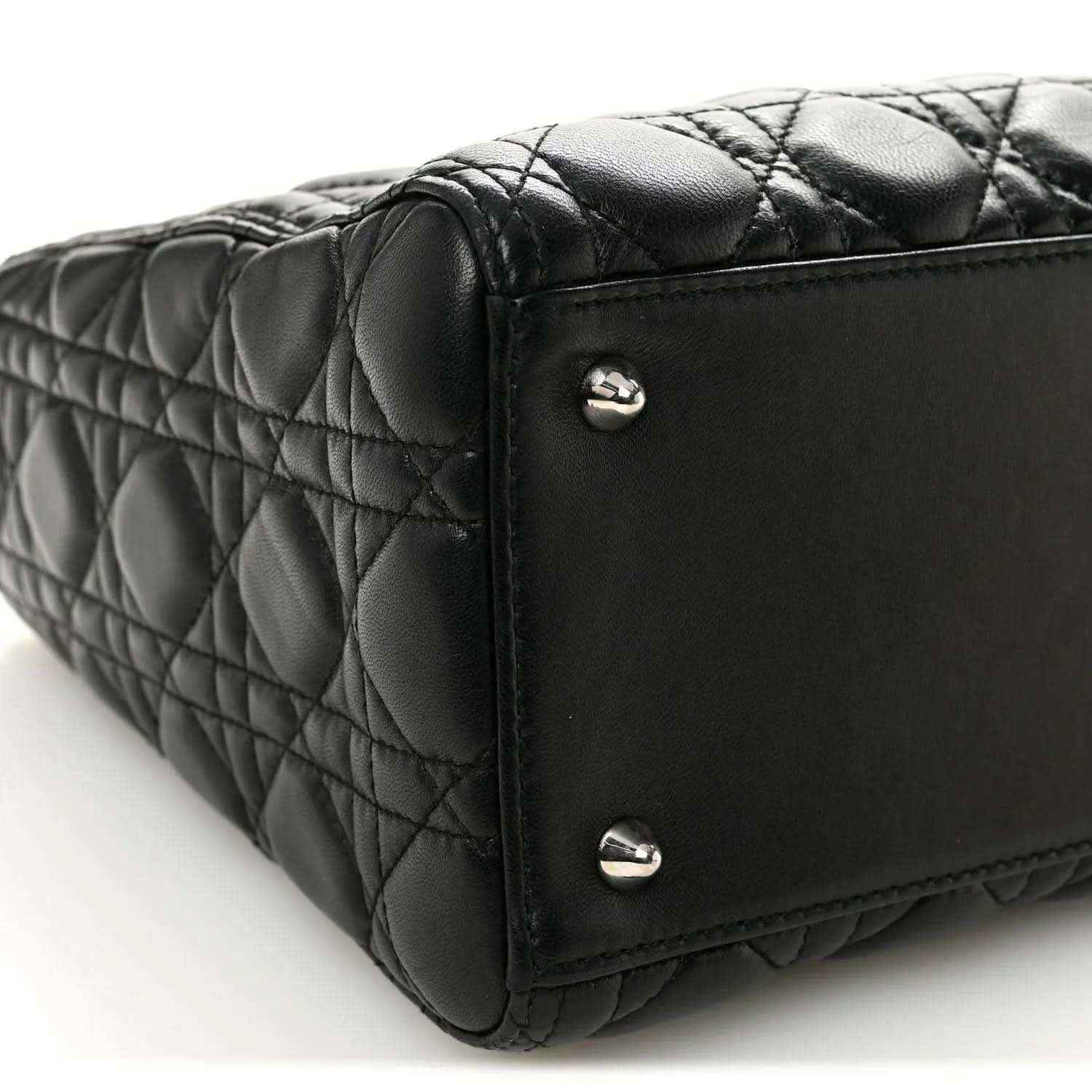 Black quilted Lady Dior handbag base corner with metal feet and stitched edge