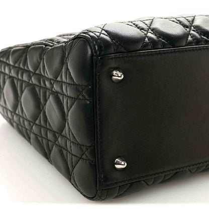 Black quilted Lady Dior handbag base corner with metal feet and stitched edge