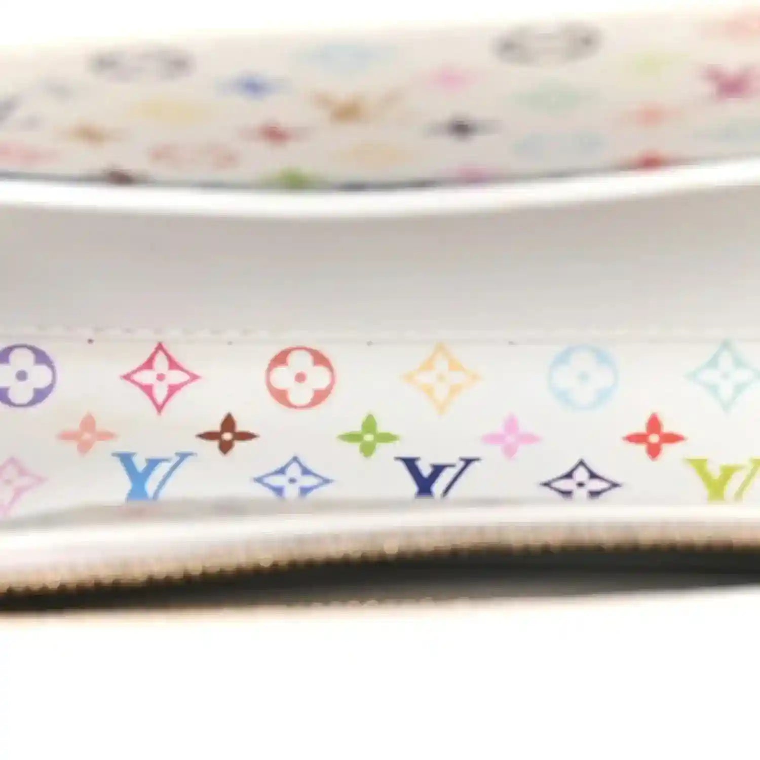 Monogram patterned lining panel with multicolor icons inside the white handbag