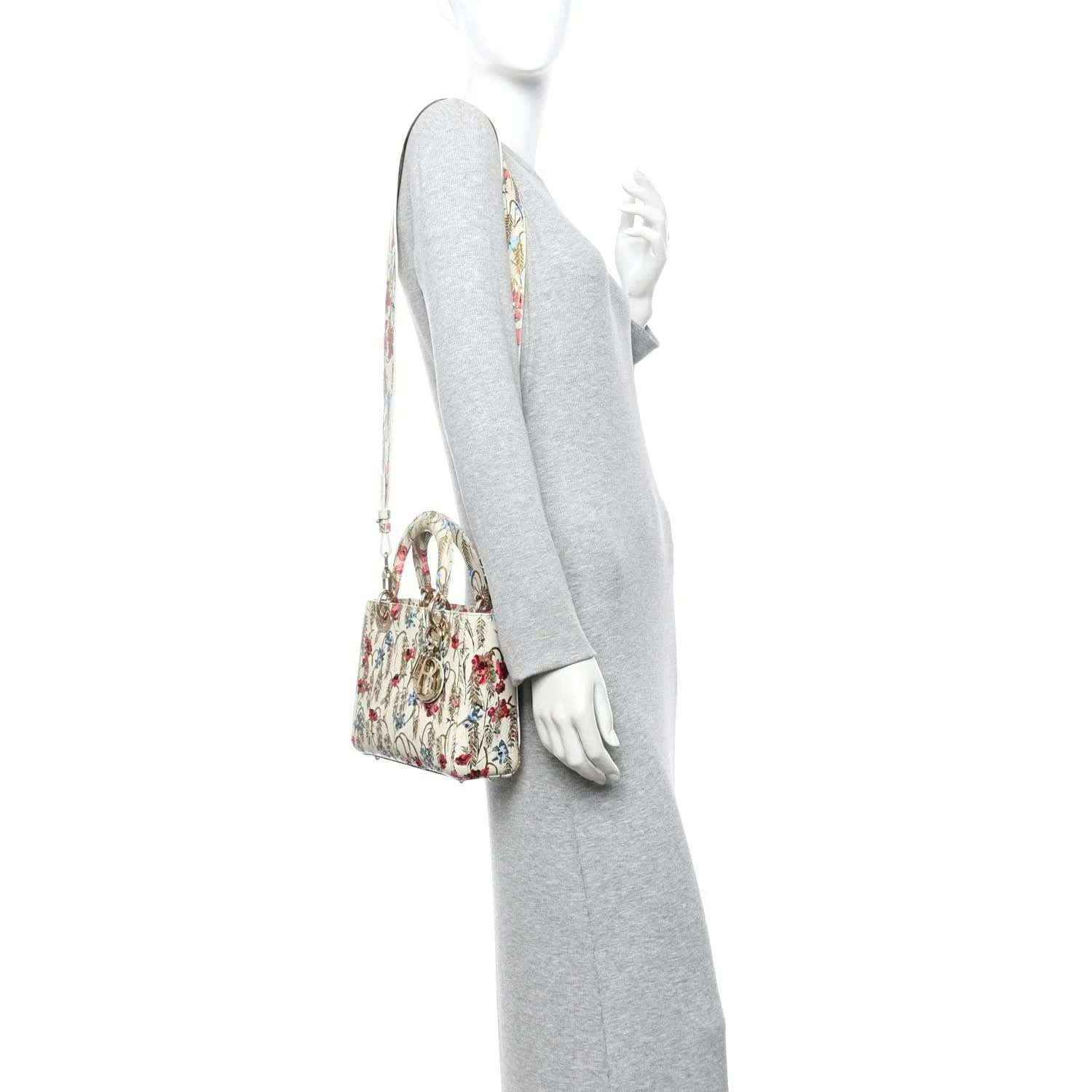 Embroidered floral tote bag with gold-tone clasp, shown on mannequin