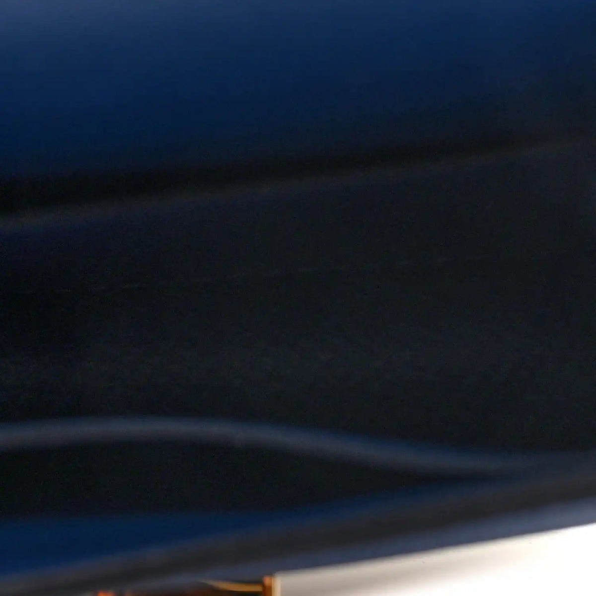 Blue leather wallet close-up of cover edge and smooth surface