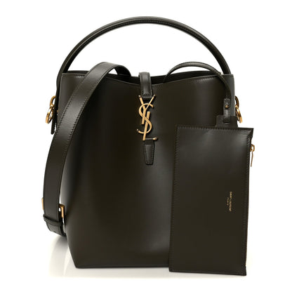 Saint Laurent bucket bag with top handles, deep musk finish, and front YSL logo plaque.