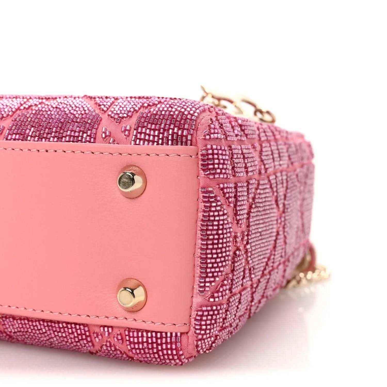 Mini Lady Dior handbag corner closeup with gold snap buttons and chain detail