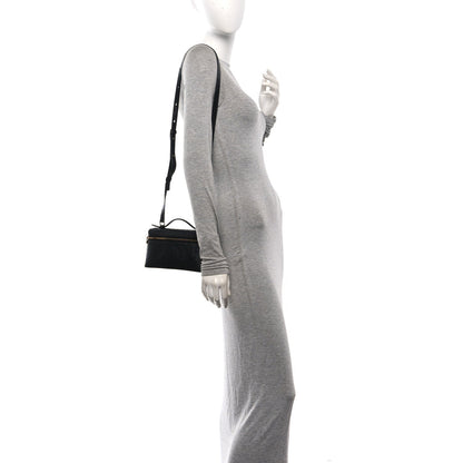 Black ostrich pocket pouch with shoulder strap worn at side on model