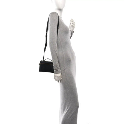 Black ostrich pocket pouch with shoulder strap worn at side on model