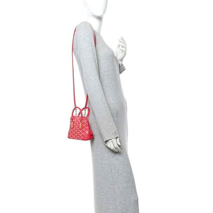 Mini handbag hanging on a mannequin, red leather and patterned body with short strap