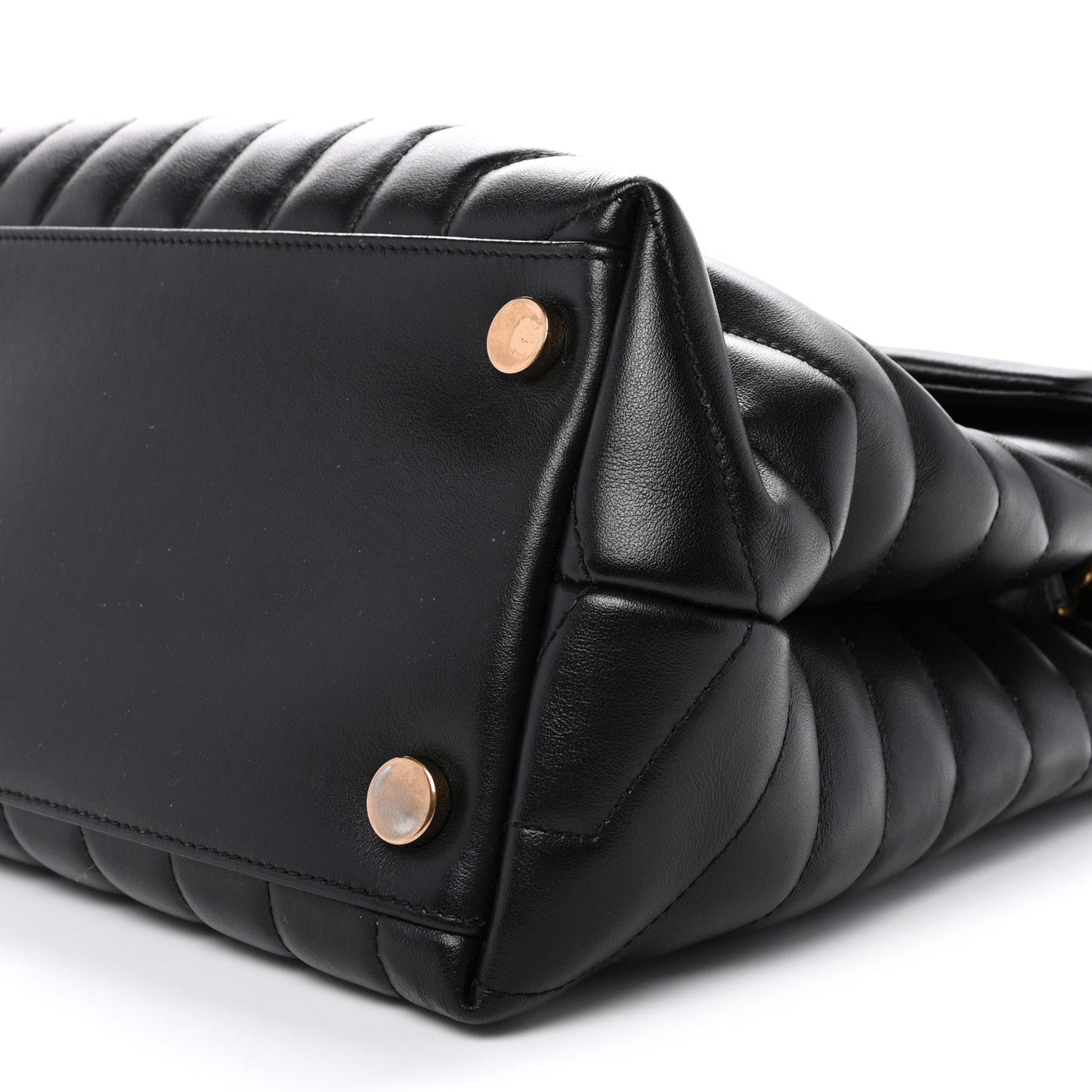 Black quilted satchel side view with leather handle and gold snap buttons