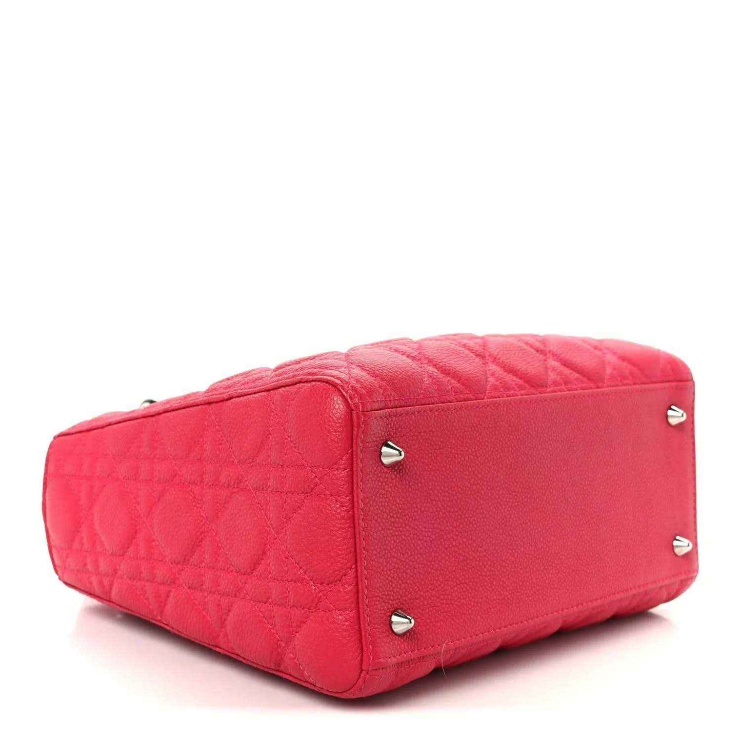 Pink quilted handbag with rounded base and silver side studs