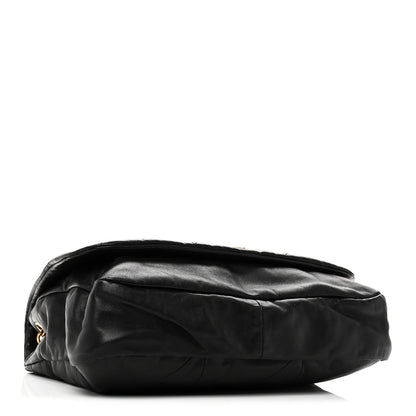 Black lambskin matelassé shoulder bag, side view with rounded flap