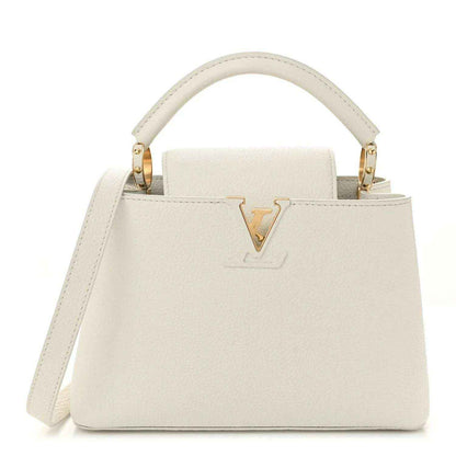 White top-handle bag with gold V logo and structured front flap