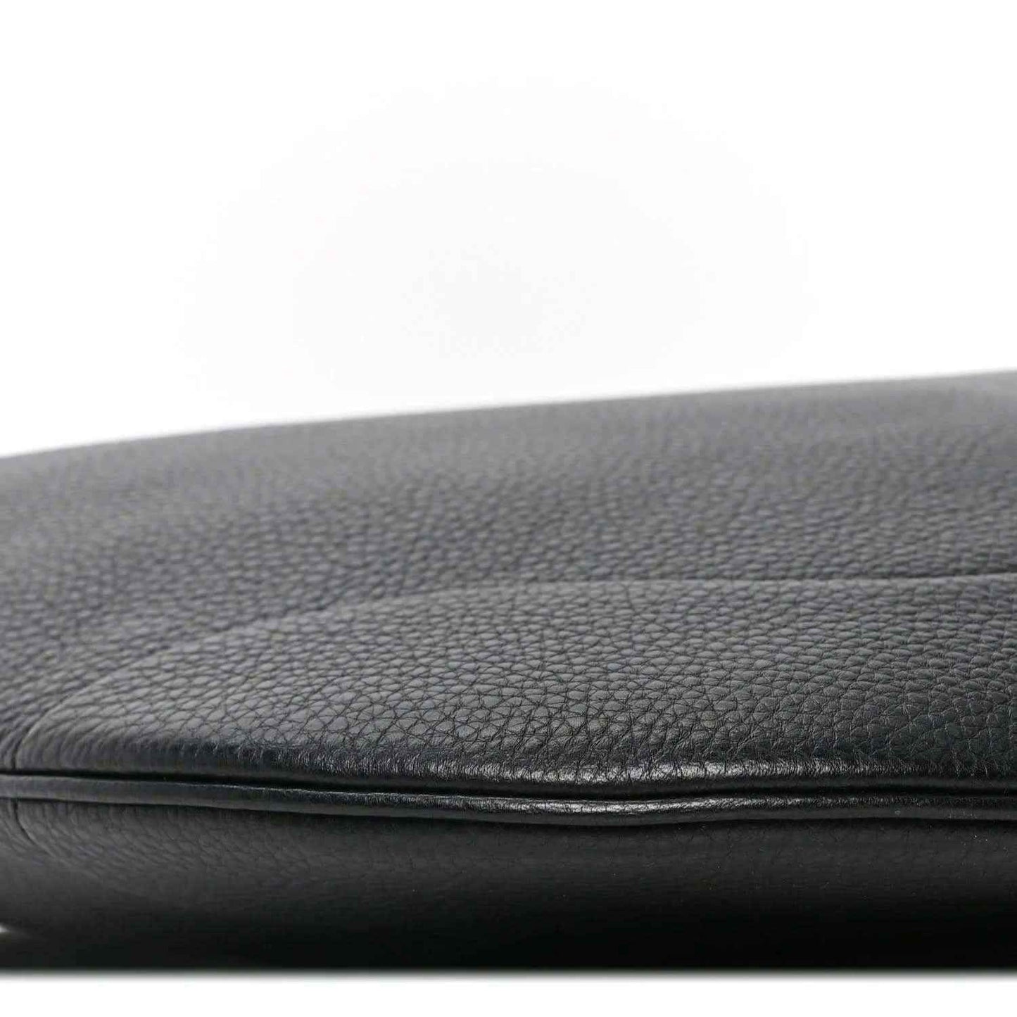 Black grained leather bag edge with stitched seam