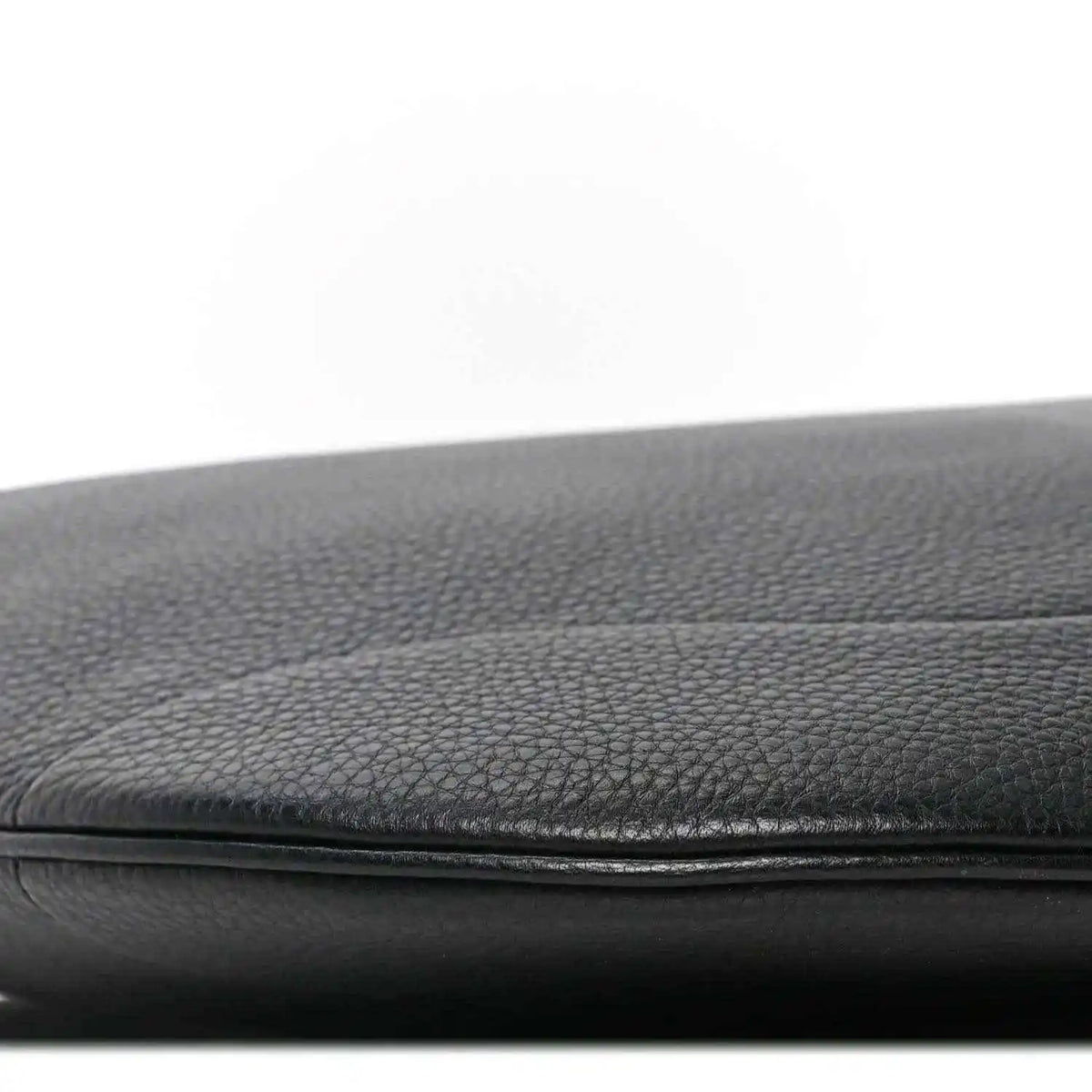 Black grained leather bag edge with stitched seam