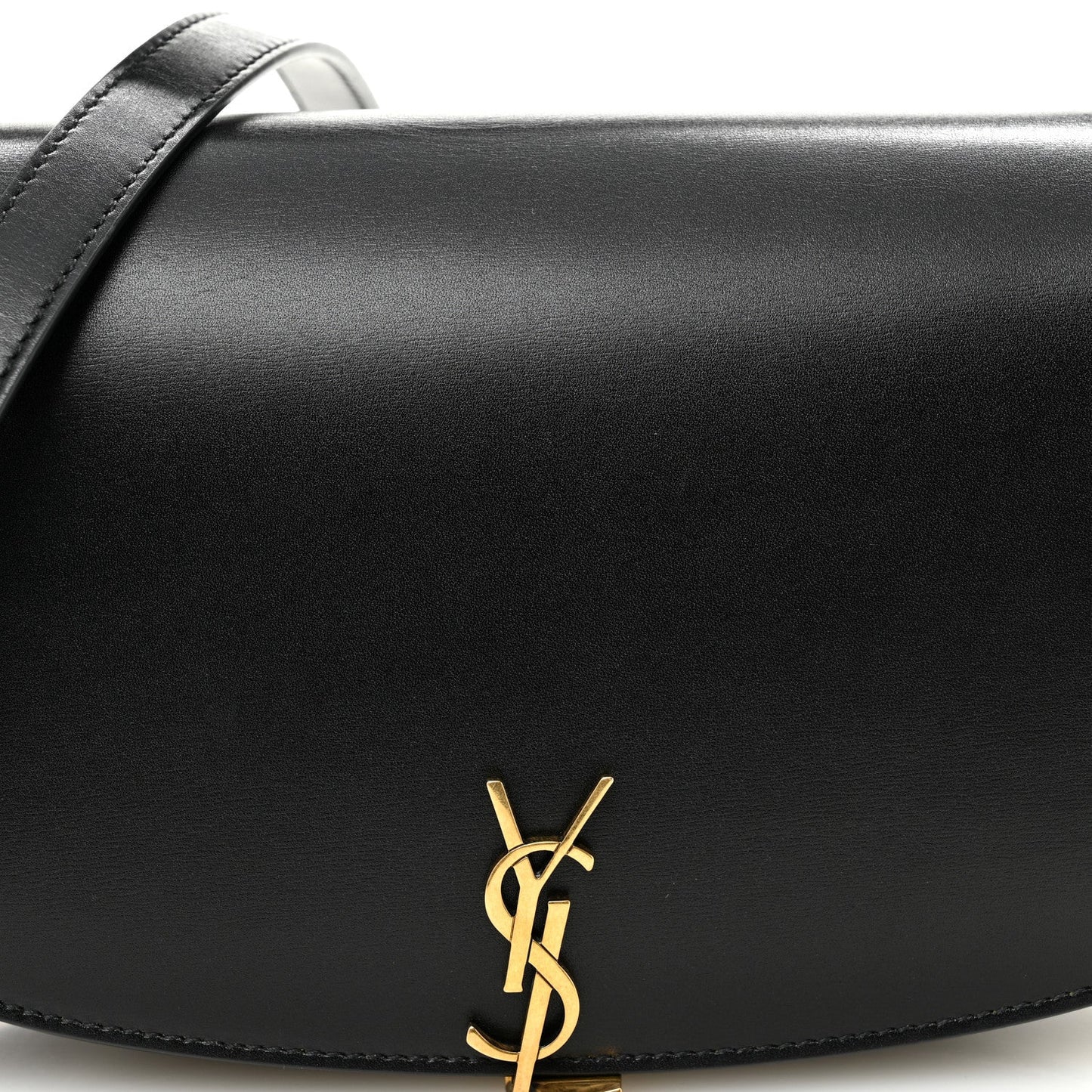 Black leather Voltaire bag front with gold YSL logo accent on curved flap.
