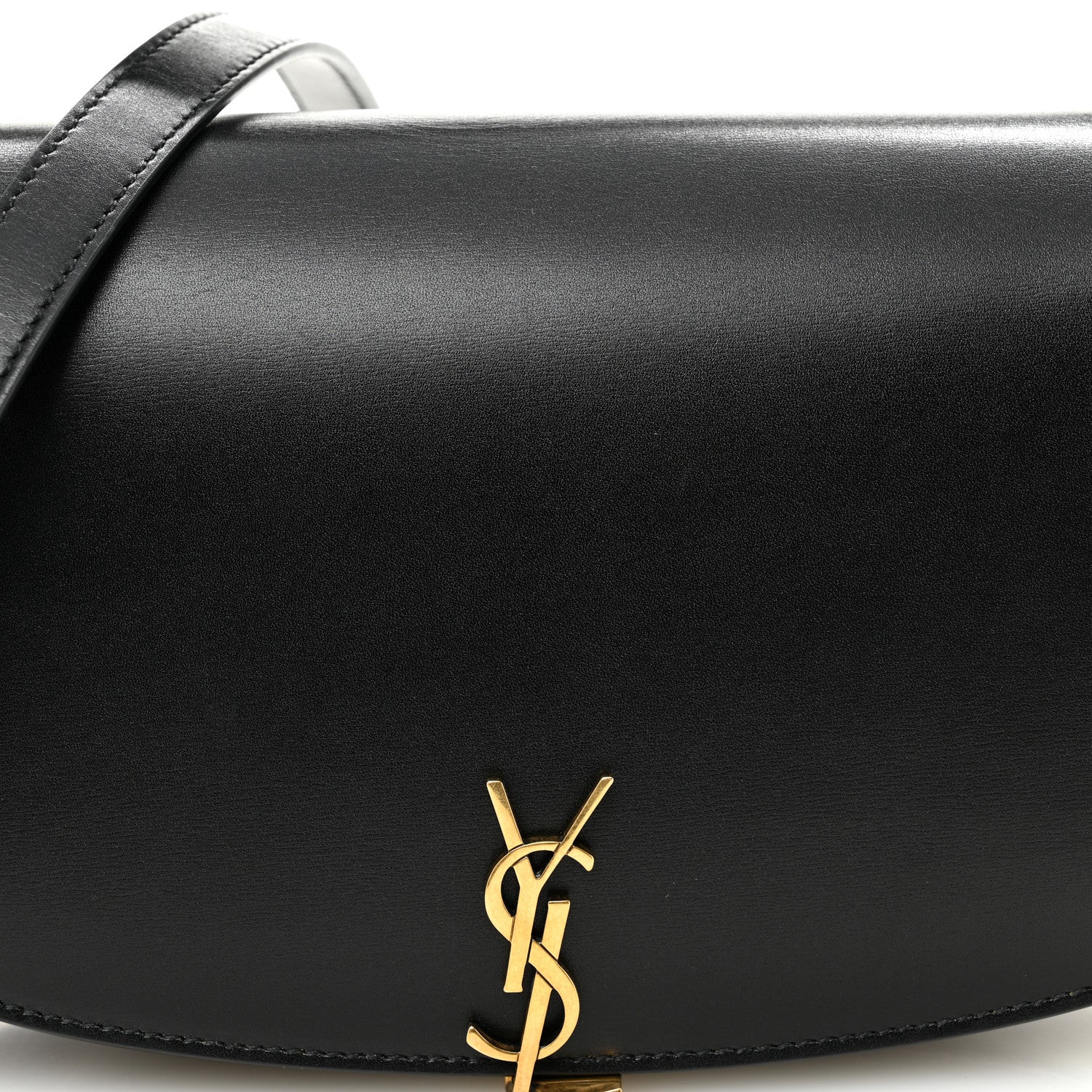 Black leather Voltaire bag front with gold YSL logo accent on curved flap.