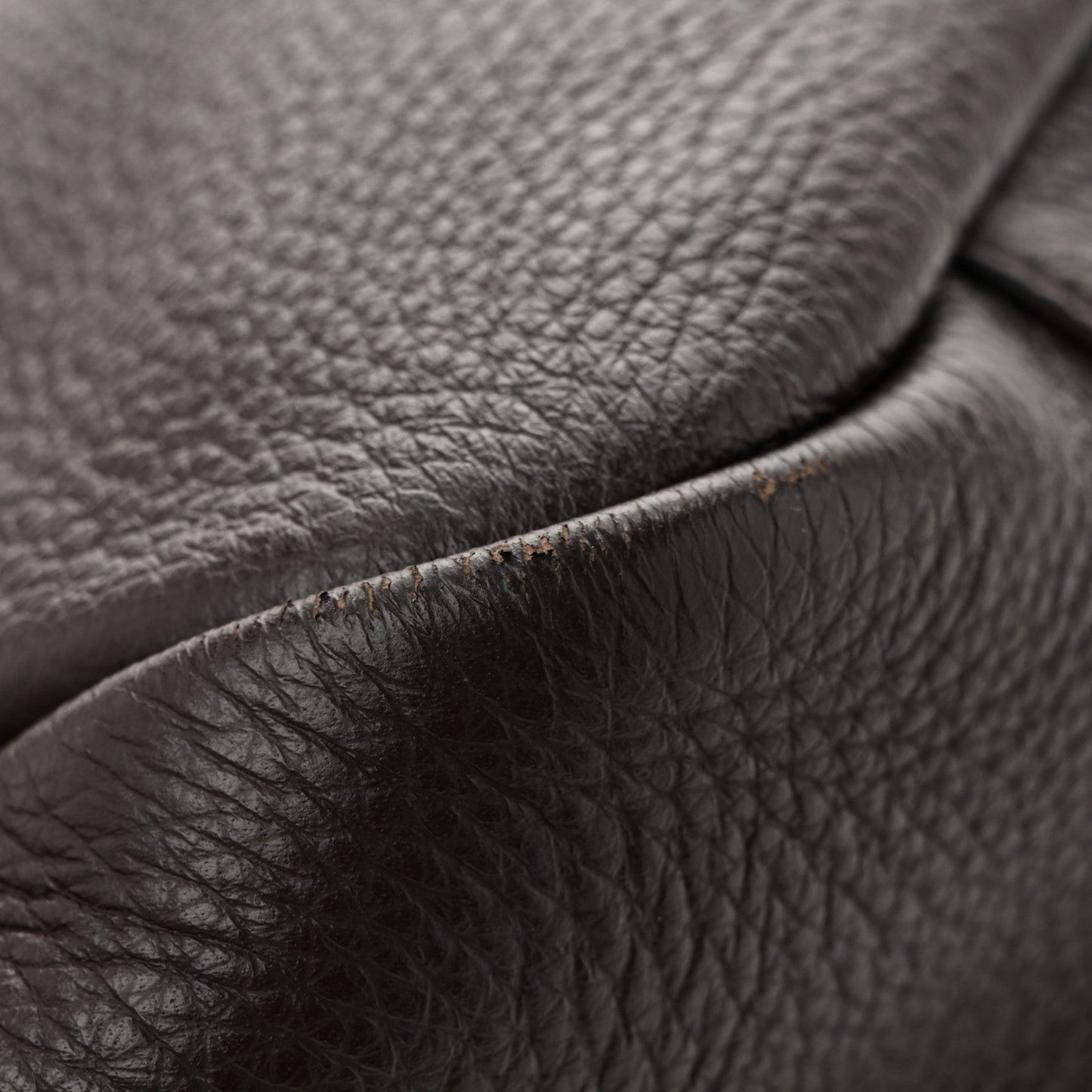 Grained deerskin tote leather detail with neat seam and brushed hardware