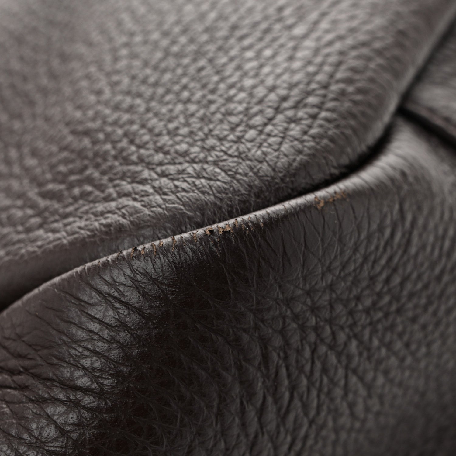 Grained deerskin tote leather detail with neat seam and brushed hardware
