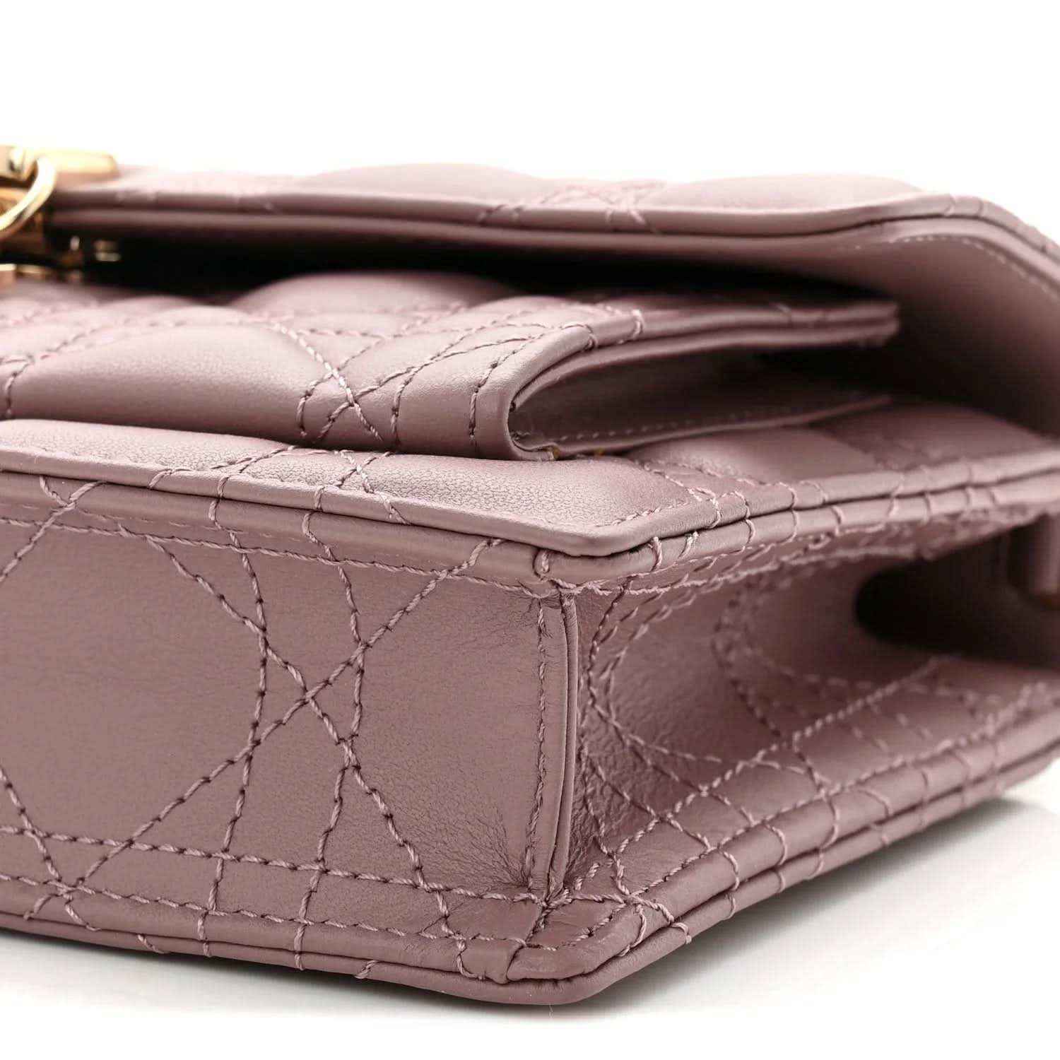 Closeup of purple quilted leather corner with flap fold and inner opening