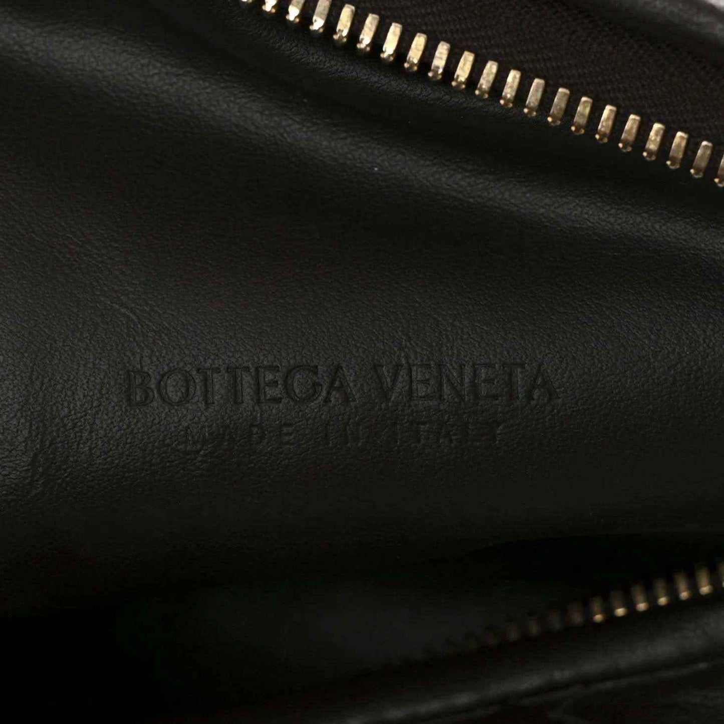 Bottega Veneta logo on dark leather lining with gold-tone zipper trim