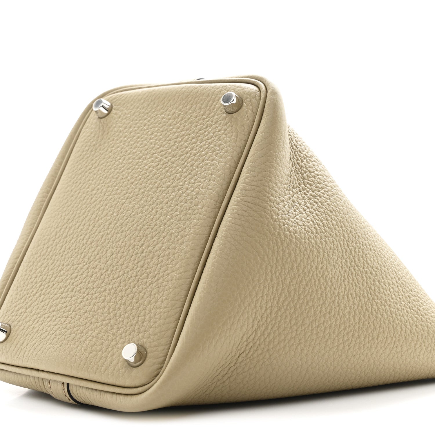 Beige leather handbag with top handles, corner snaps, and triangular fold shape