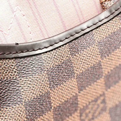 Damier Ebene tote trim with dark leather piping and visible stitching on canvas