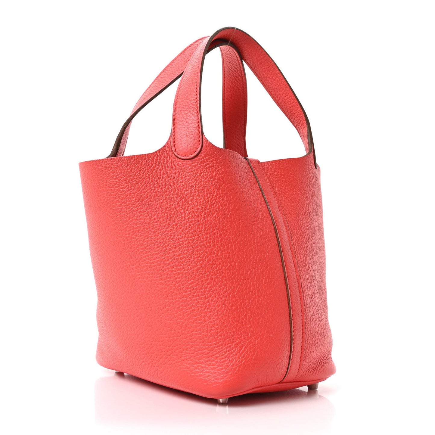 Red leather tote bag with wide top handles and structured trapezoid shape