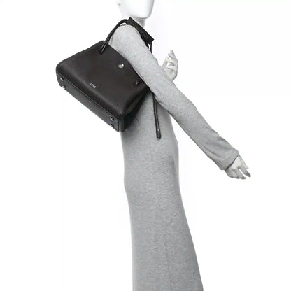 Loewe Madrid medium bag in dark leather with wrist strap and top handle loop
