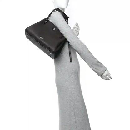 Loewe Madrid medium bag in dark leather with wrist strap and top handle loop