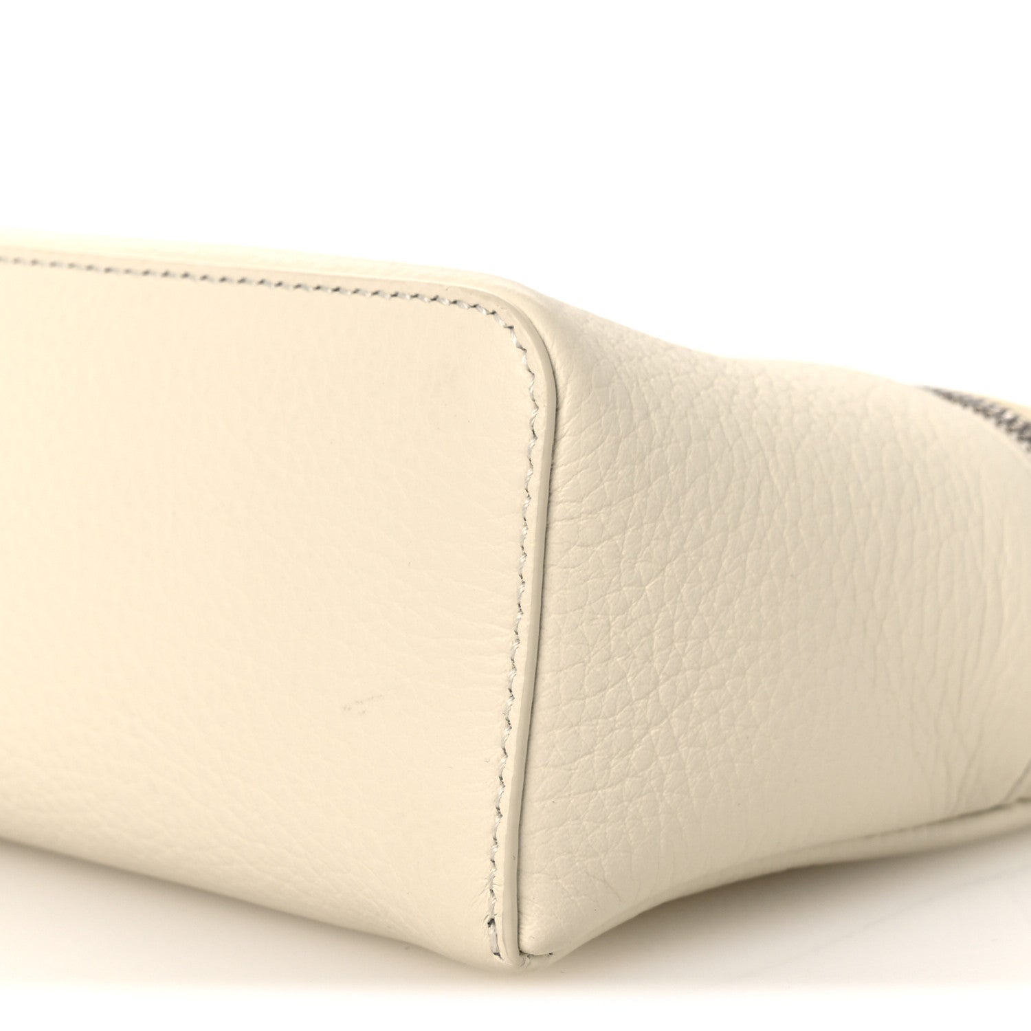 White grained calfskin pouch corner with neat topstitched edge, close-up