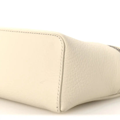 White grained calfskin pouch corner with neat topstitched edge, close-up