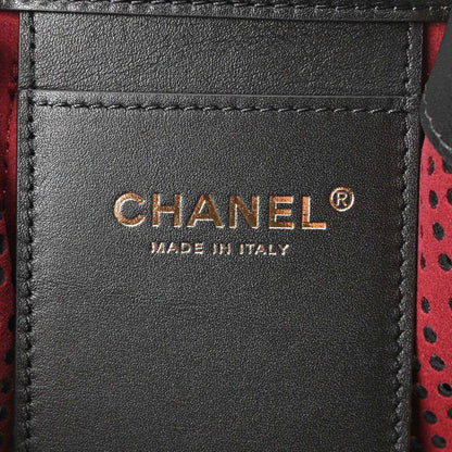 Chanel handbag label on black leather panel, made in Italy text