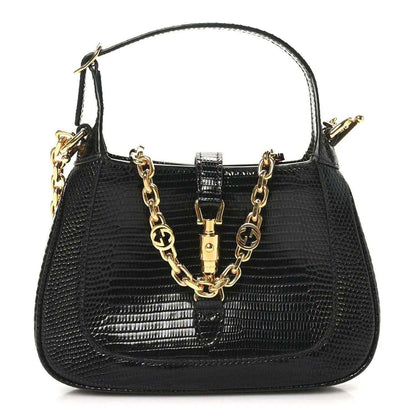 Gucci black lizard mini Jackie handbag with top handle, chain strap, and gold clasp hardware.
