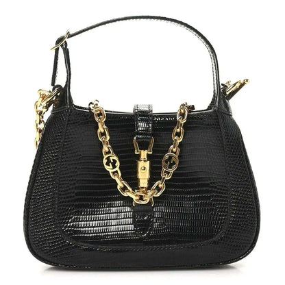 Gucci black lizard mini Jackie handbag with top handle, chain strap, and gold clasp hardware.