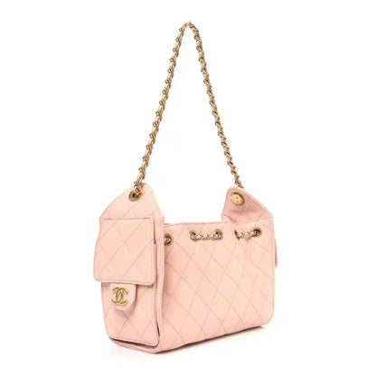 Light pink quilted mini handbag with front flap pocket and gold-tone chain strap