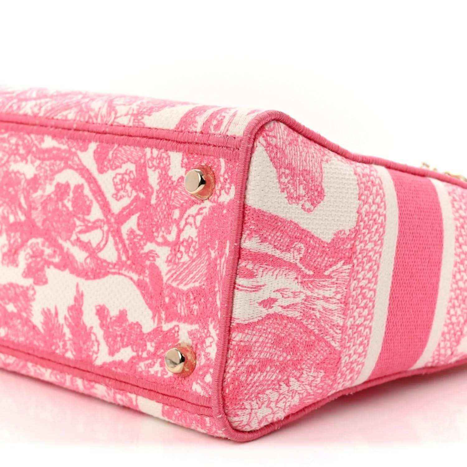 Pink patterned tote bag with short handles and side panel, gold snap details