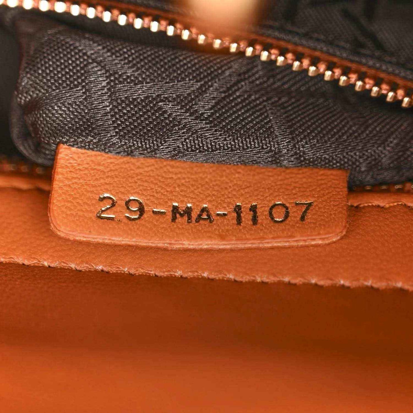 Authenticity tag 29-MA-1107 inside orange Lady Dior tote near zipper opening