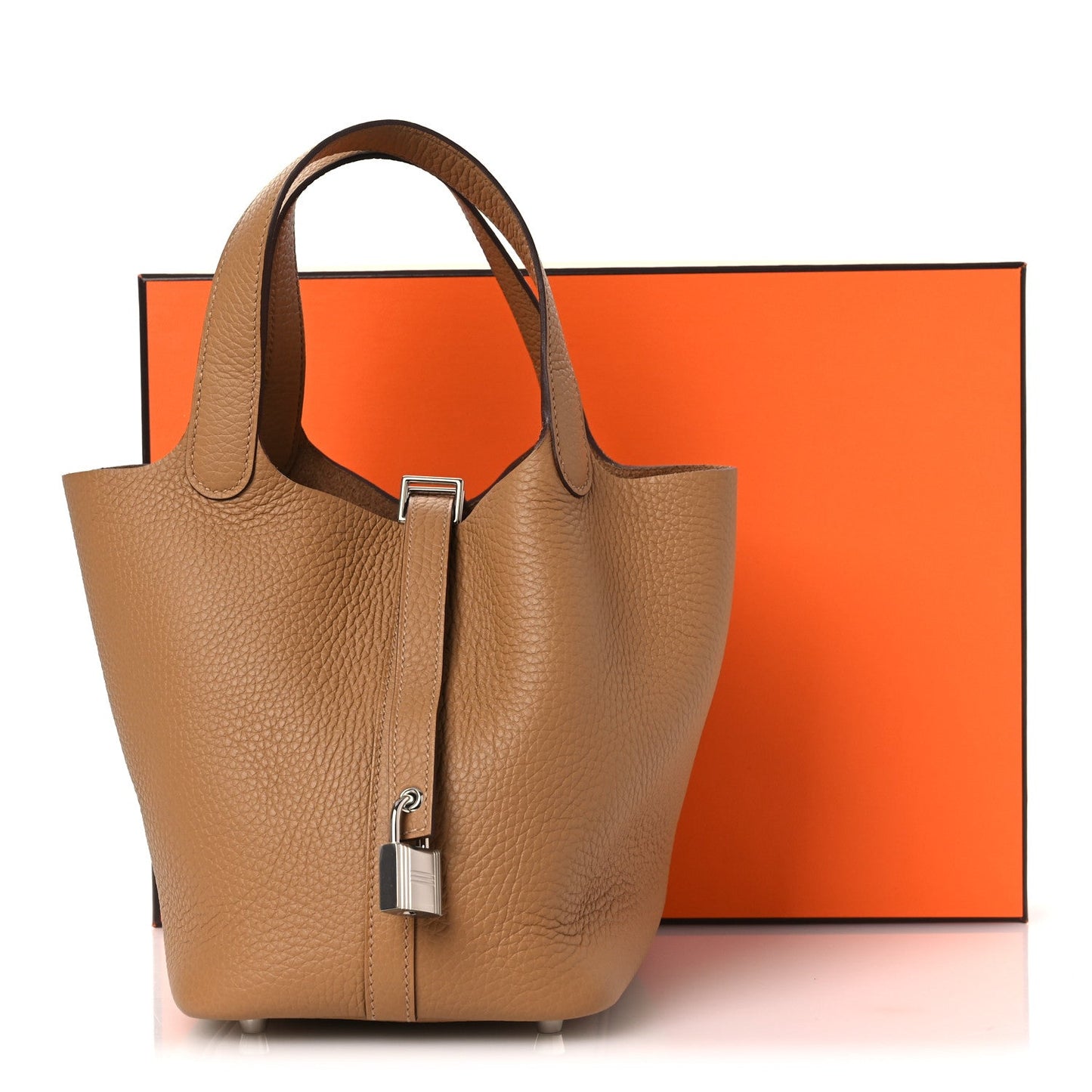 Tan pebbled leather tote bag with top handles and front lock clasp.