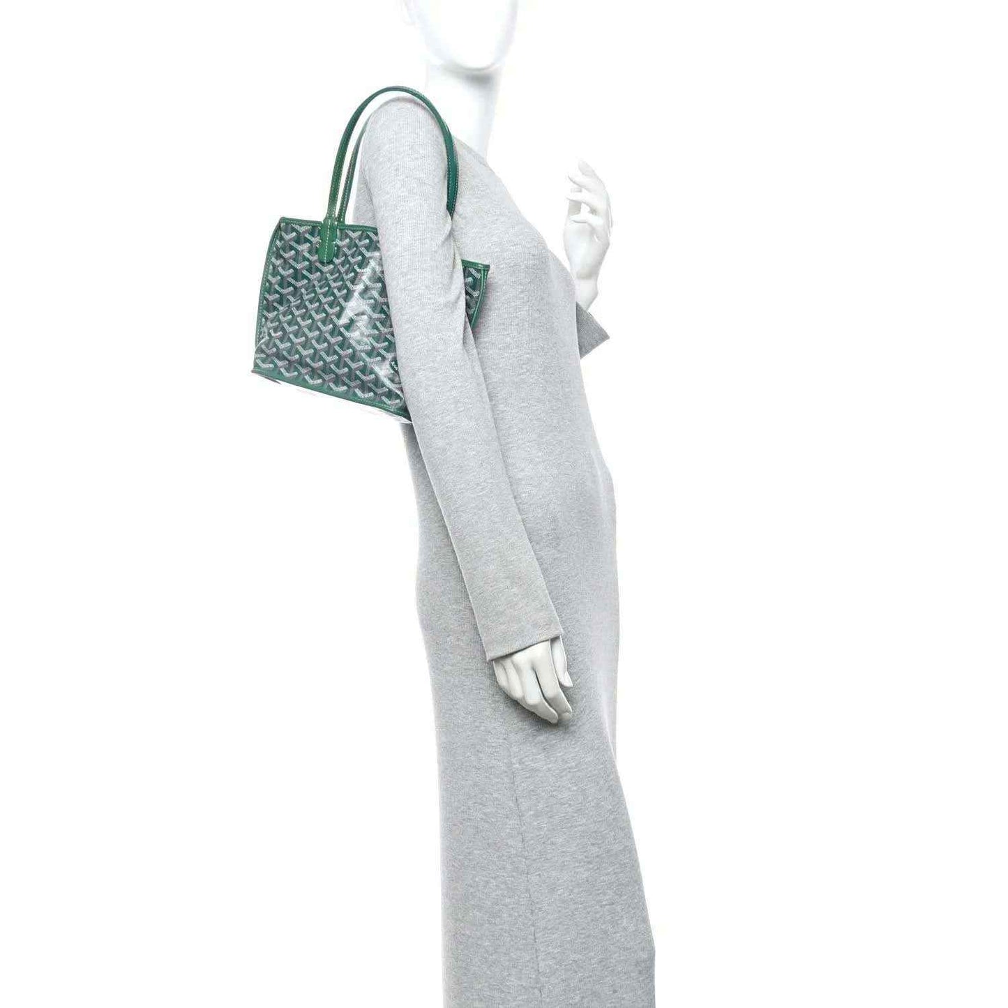 Green reversible mini tote bag shown from side with top handles and patterned body