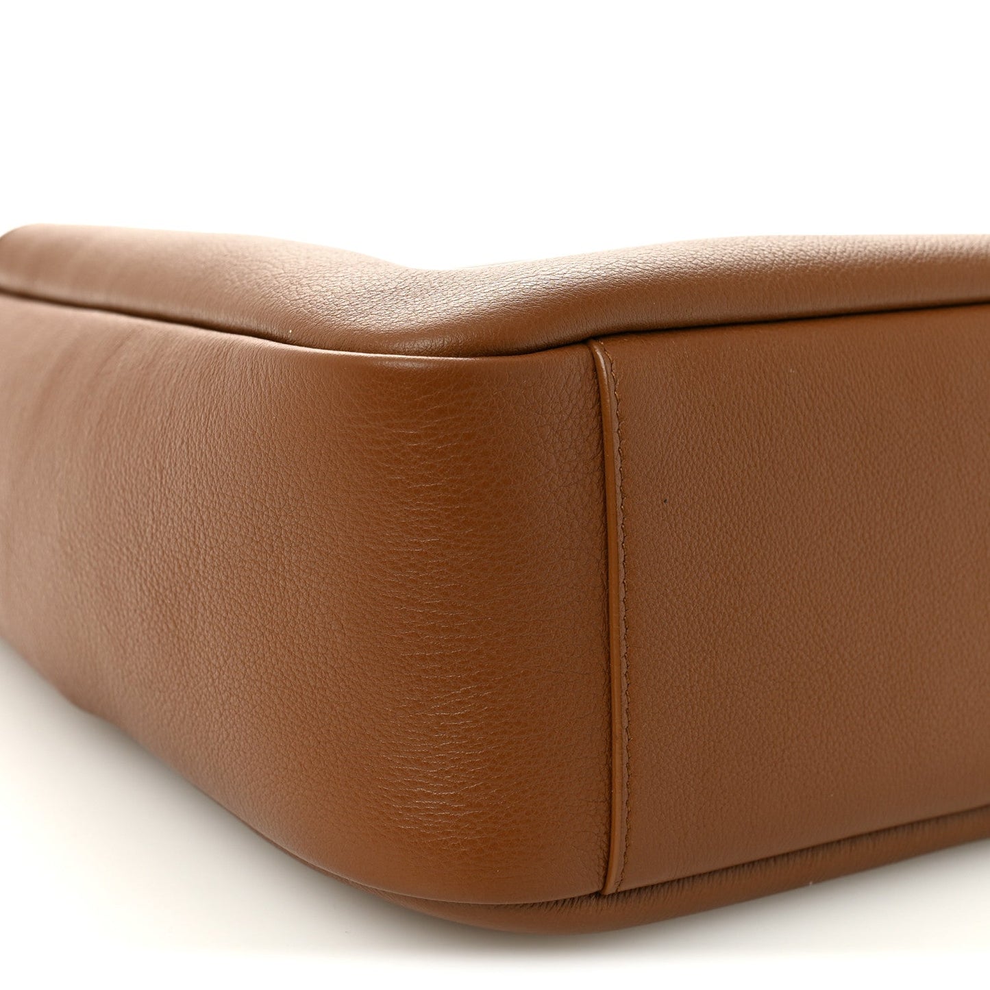 Tan leather hobo bag corner with smooth paneling and rounded base