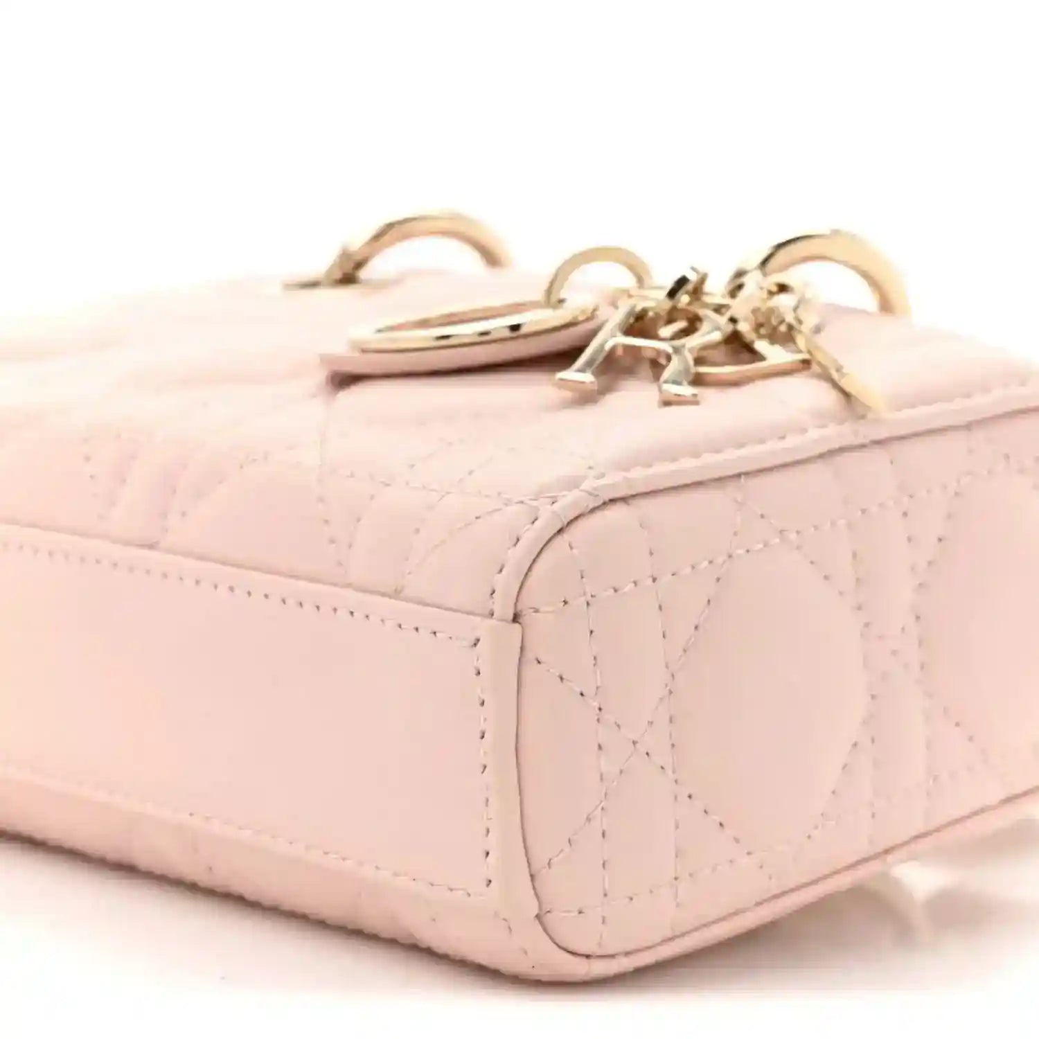 Pink quilted leather mini handbag top edge with gold chain and hardware