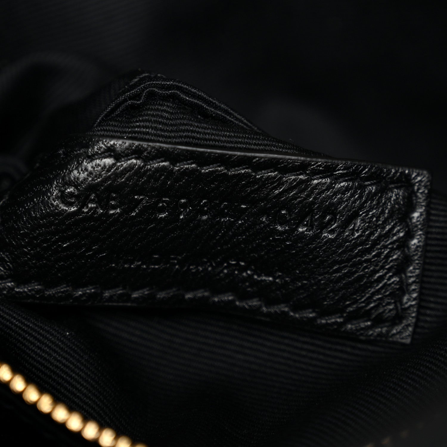 Saint Laurent quilted lambskin interior close-up with stitched seam and zipper