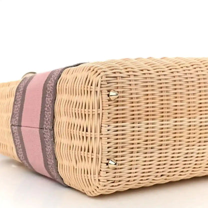Wicker bag end with pink and gray striped band and gold corner studs