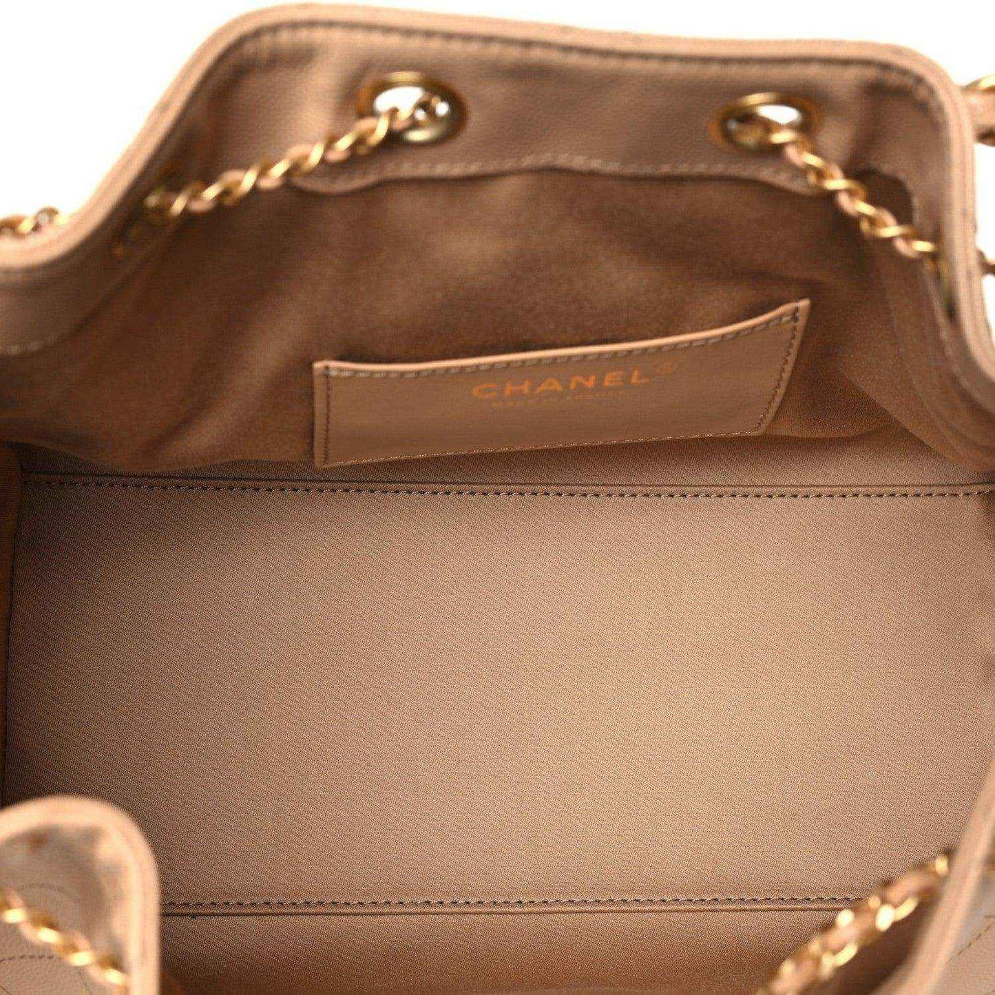 Chanel small 25 handbag interior with fabric lining and Chanel label near top edge