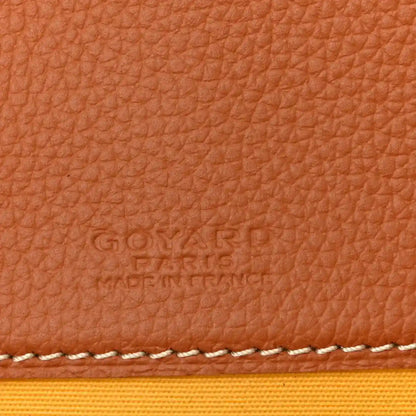 Tan leather panel with embossed brand text and white contrast stitching