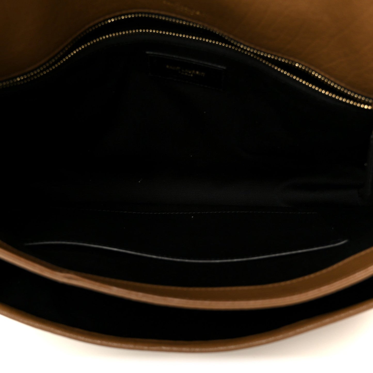 Satchel interior with zippered opening and dark lining, grained leather trim.